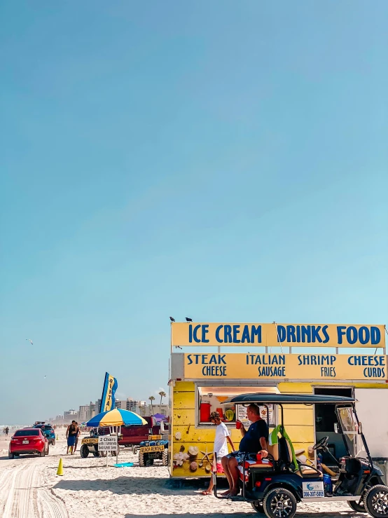 an ice cream shop is lined up on the beach