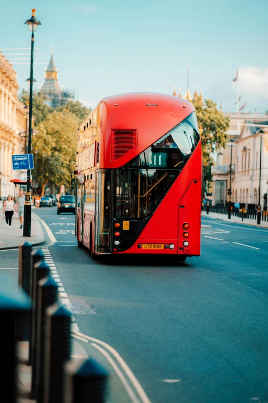 a large red bus traveling down a busy street