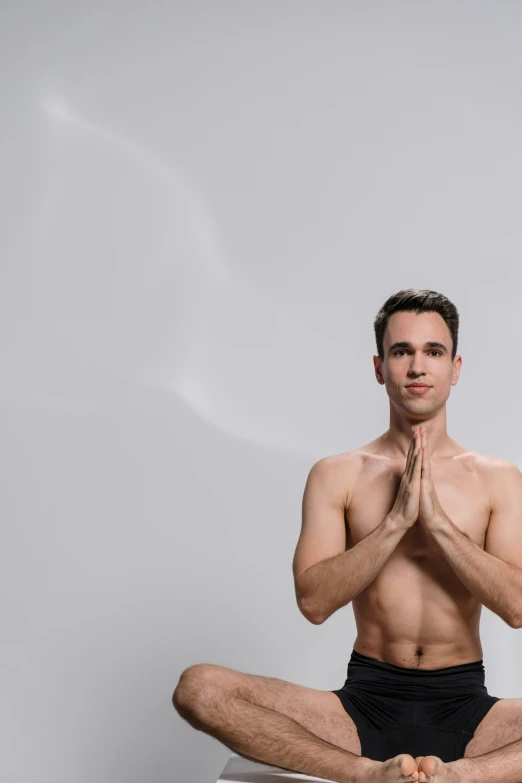 man in black underwear sitting on top of white chair