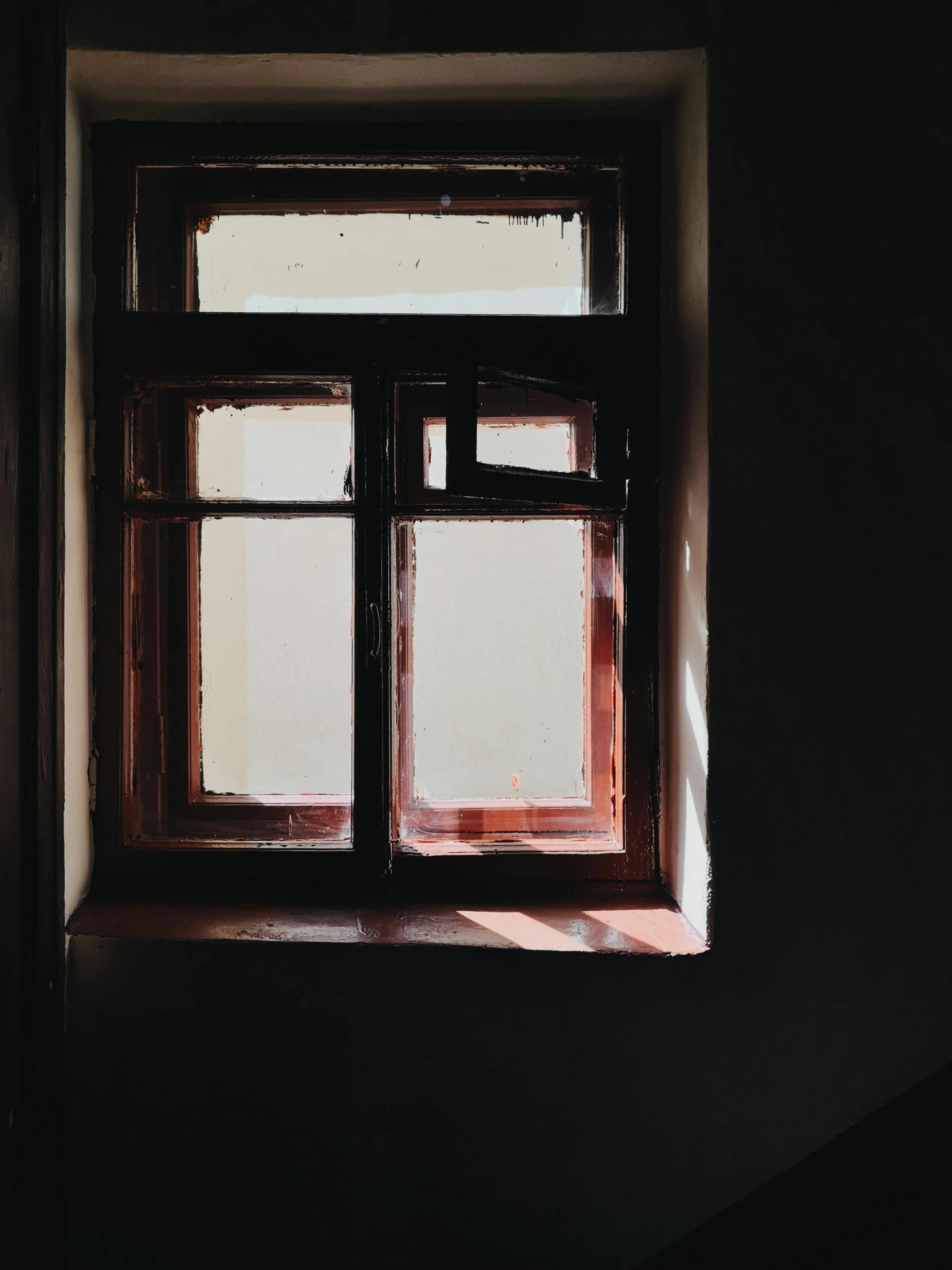 a small window sits in the corner of the room