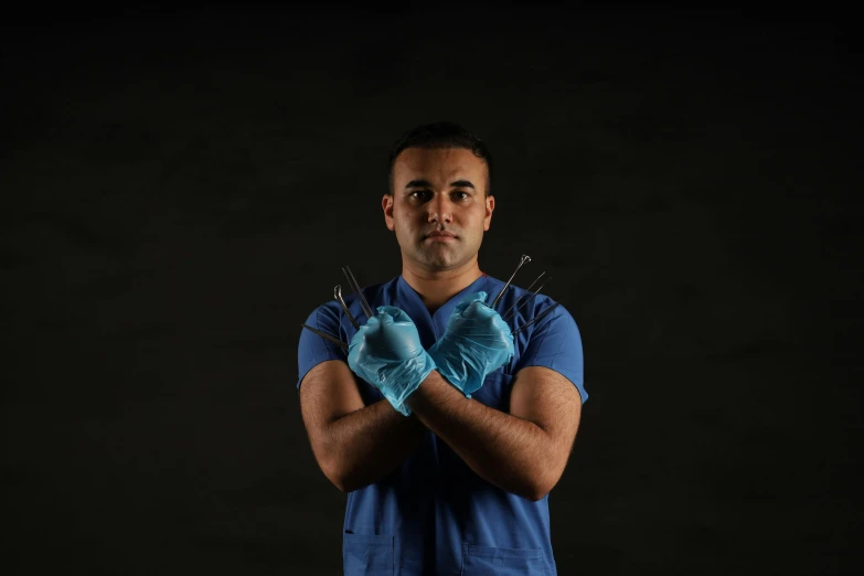 a man with a glove on standing in front of a black background
