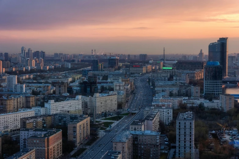 a city with tall buildings with a sunset in the background