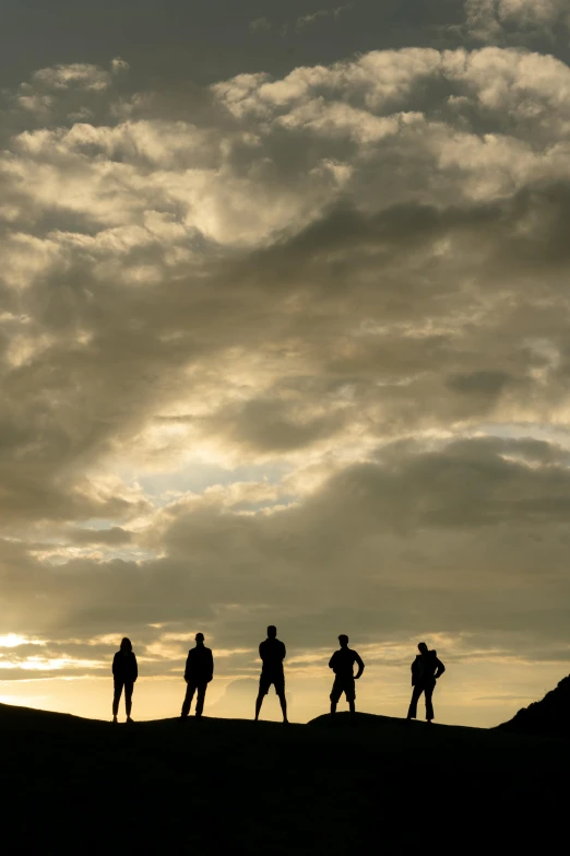 a group of people standing on top of a hill