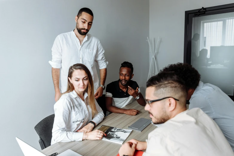 people sitting around a table looking at each other