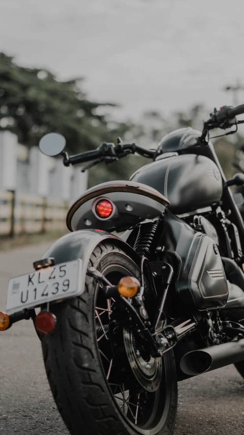 a black motorcycle parked on the street next to another bike