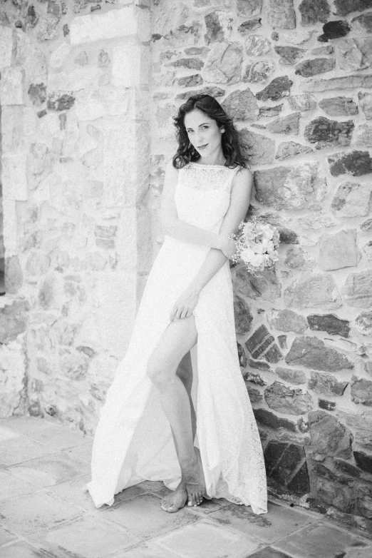 a woman in a wedding dress poses for a black and white po