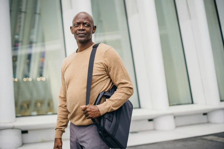 an older man is standing outside of a building