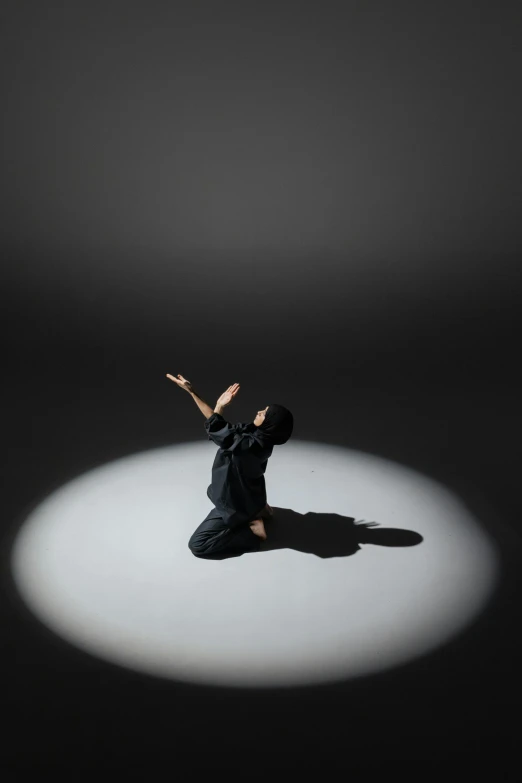 a man in a black shirt is sitting on a circle