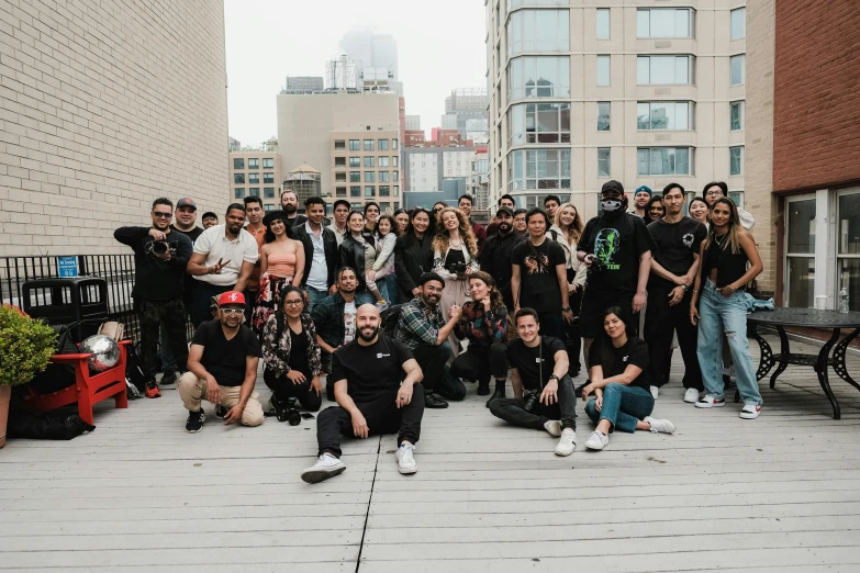 group of people posing for a po with buildings in the background