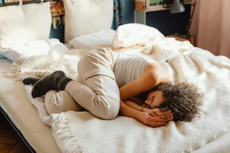 a woman laying on her stomach in bed