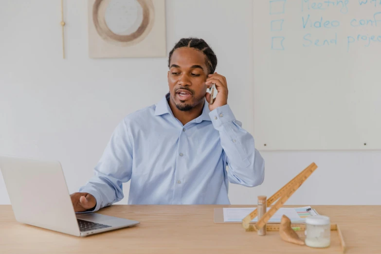 a man on his cell phone and laptop