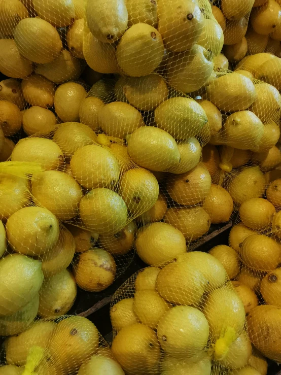 the produce is piled high and full of yellow colored fruit