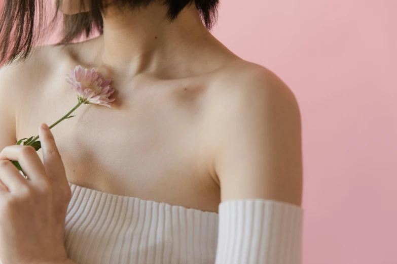 the women in a white dress has a flower in her hand