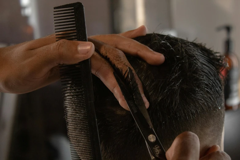 this is a man  his hair with a comb