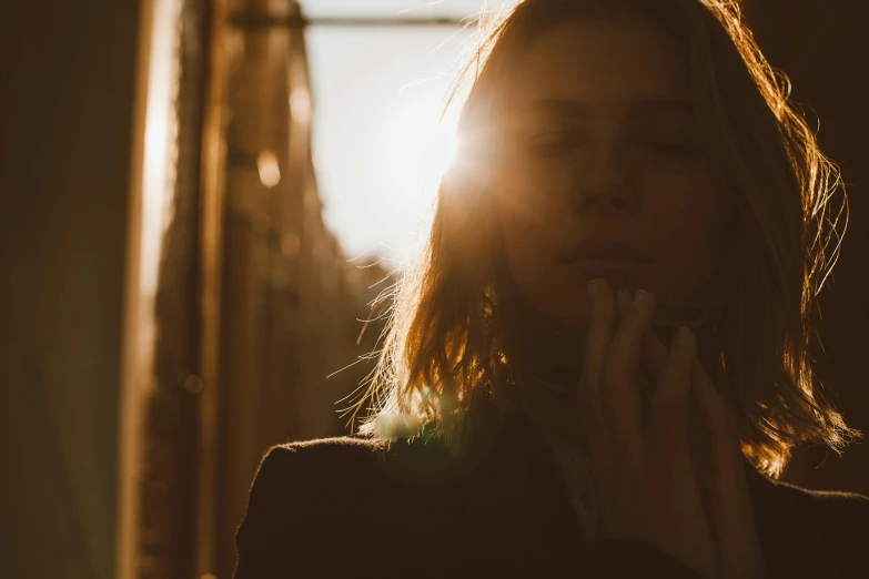 the girl has long brown hair and is taking a smoke break