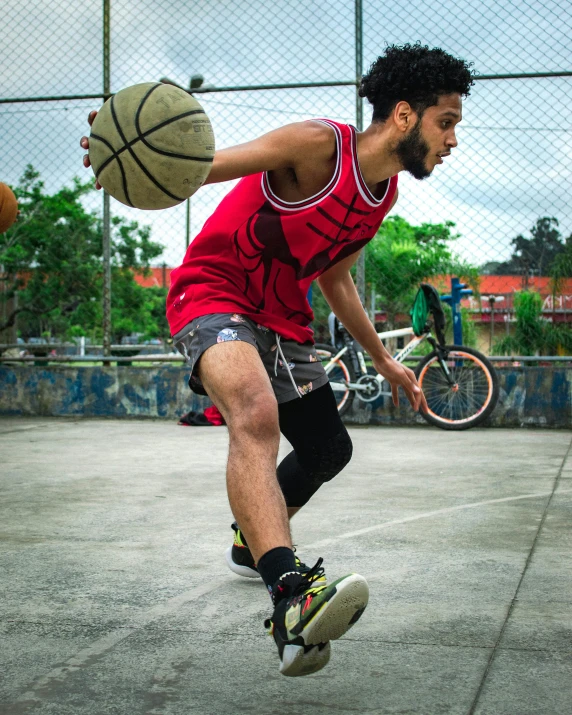 a man with a bicycle and ball jumping up in the air