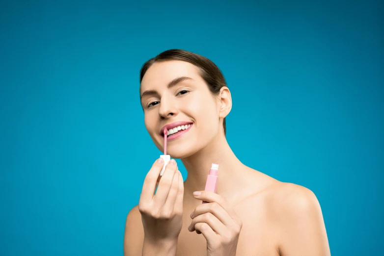 a young woman putting a tooth brush in her mouth