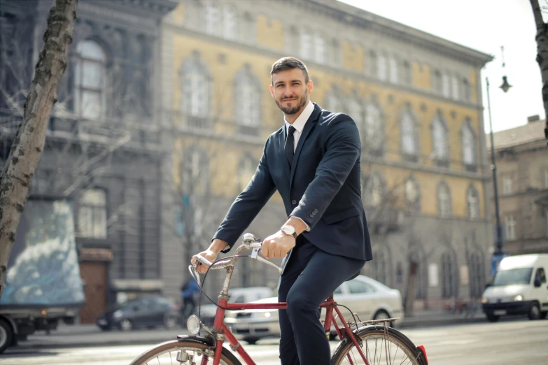 man in a suit on a bike wearing a watch