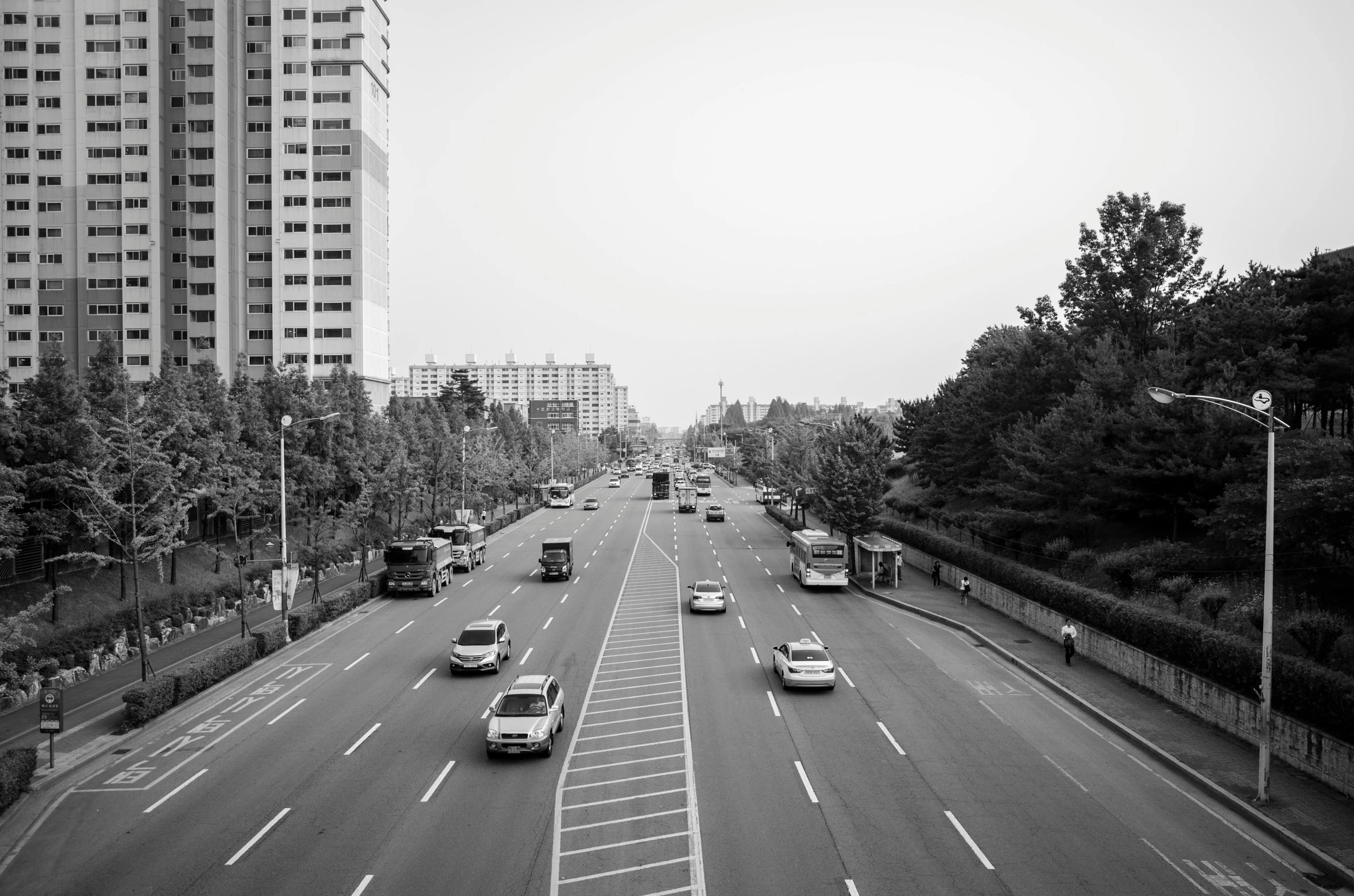 black and white pograph of vehicles moving on a city street