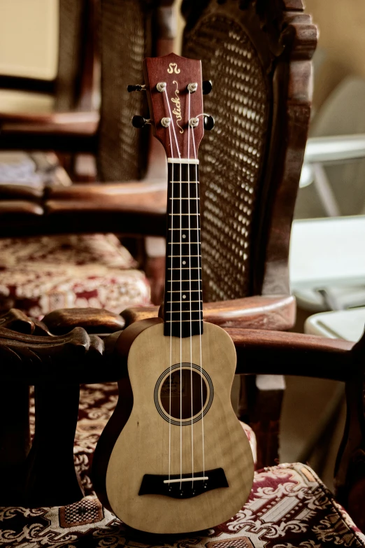 a wooden guitar is placed on top of an ornate table