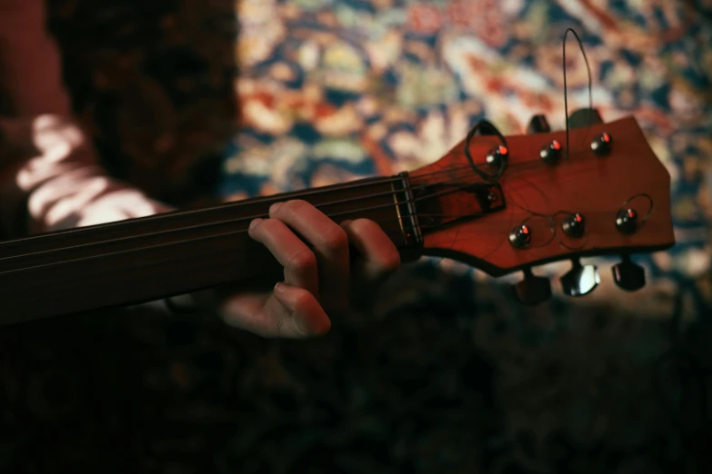 the neck of an electric guitar being held