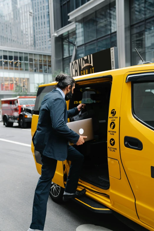 a man is loading cardboard into a taxi car