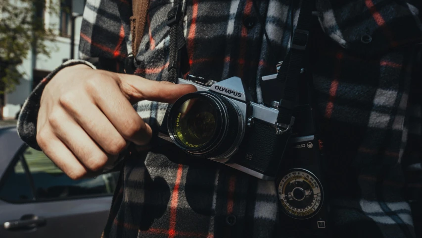 the person is holding their camera to take a picture