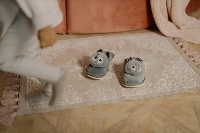 two stuffed animals with shoes on the floor