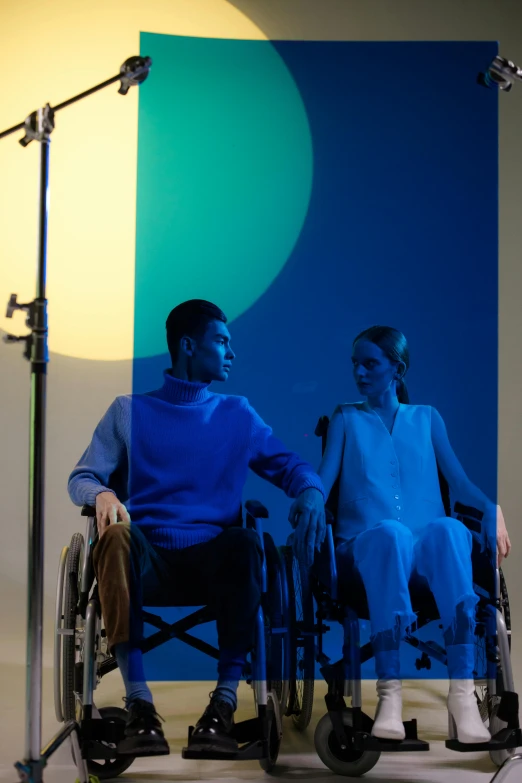 a man in a wheelchair talking to a woman