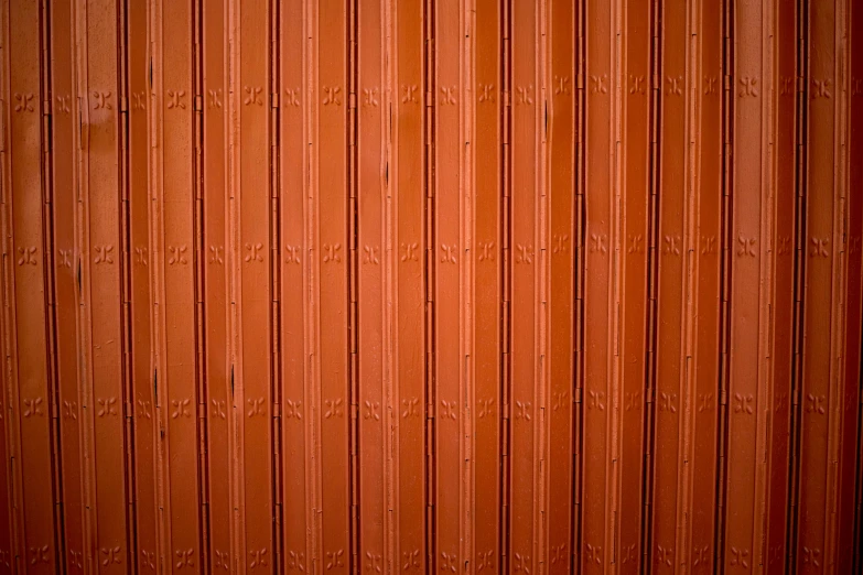 an orange door that has vertical wooden panels on it