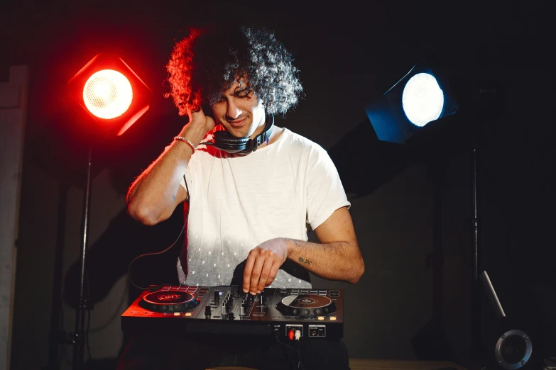 a dj mixing music in front of light bulbs