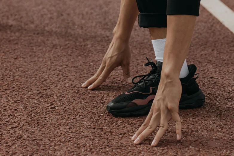 a person with both hands on the ground with a soccer ball