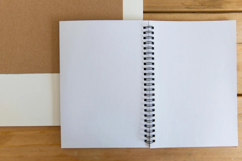 an open notebook sitting on top of a wooden table