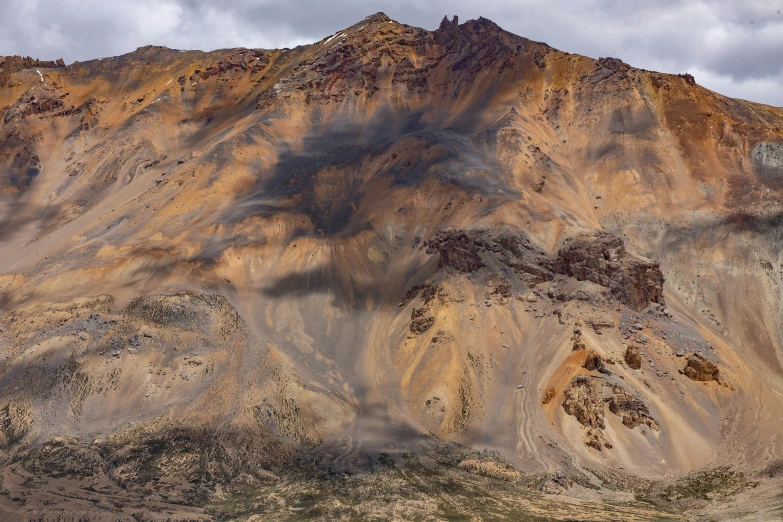 an up - close po of a mountain on a cloudy day