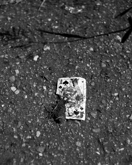 broken lighter laying in the road on its side