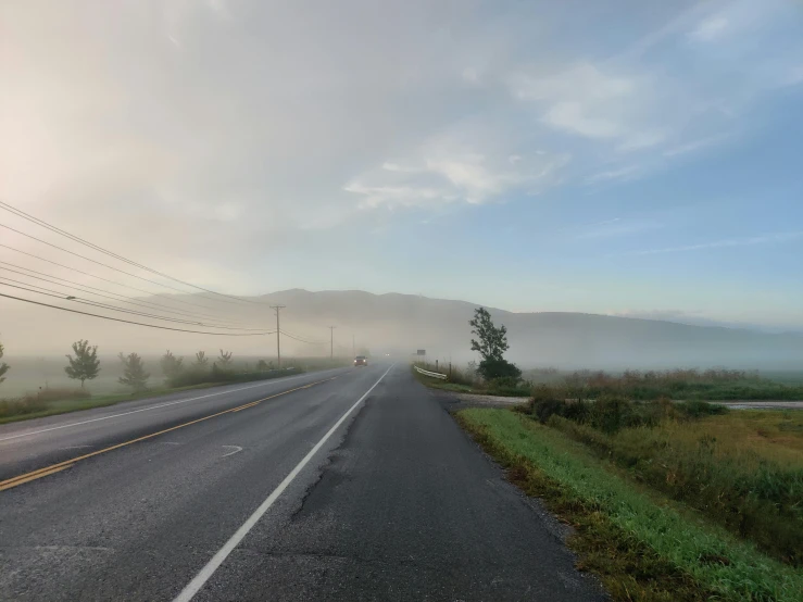 a highway that has fog on the ground