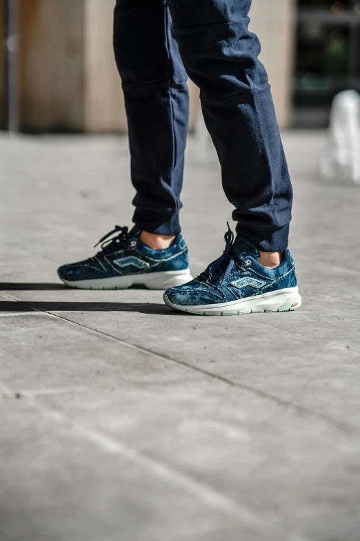 someone wearing sneakers on the street, casting a shadow