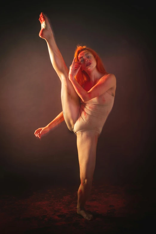 a  woman with long legs and red hair standing in the dark