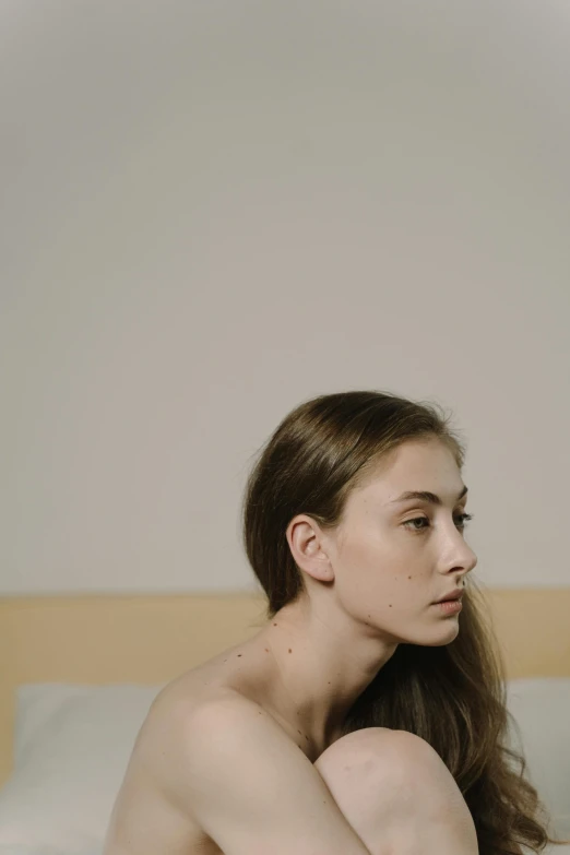 a woman sitting  in a white bed