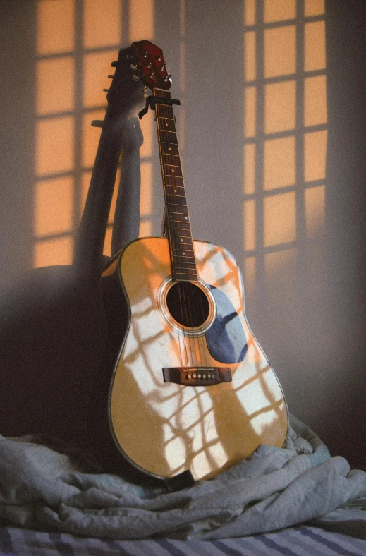 the guitar leaning against the wall is casting a shadow