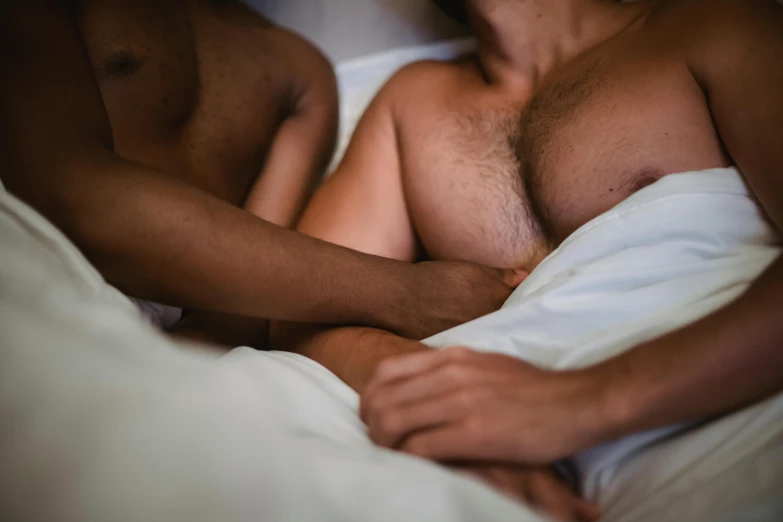 an image of a shirtless man and woman sleeping