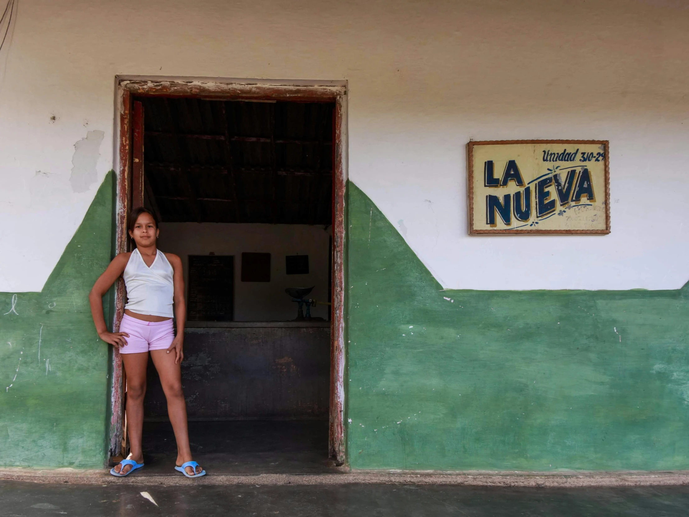 a woman standing in front of the door of a building