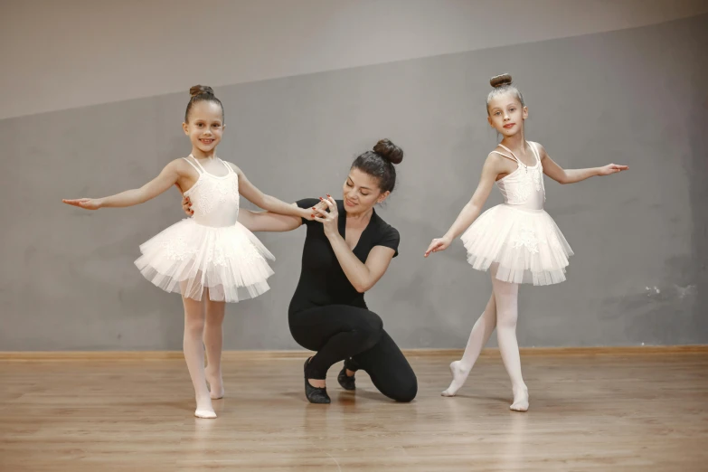 a girl in ballet tutu with three other girls