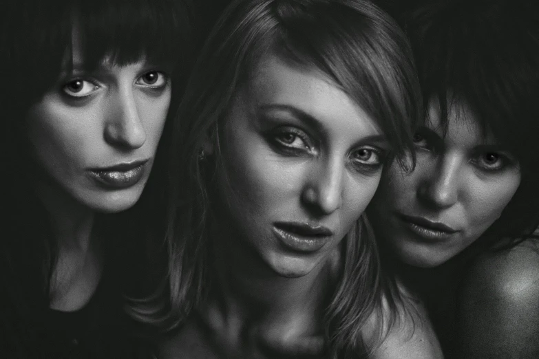 three women pose for a black and white picture