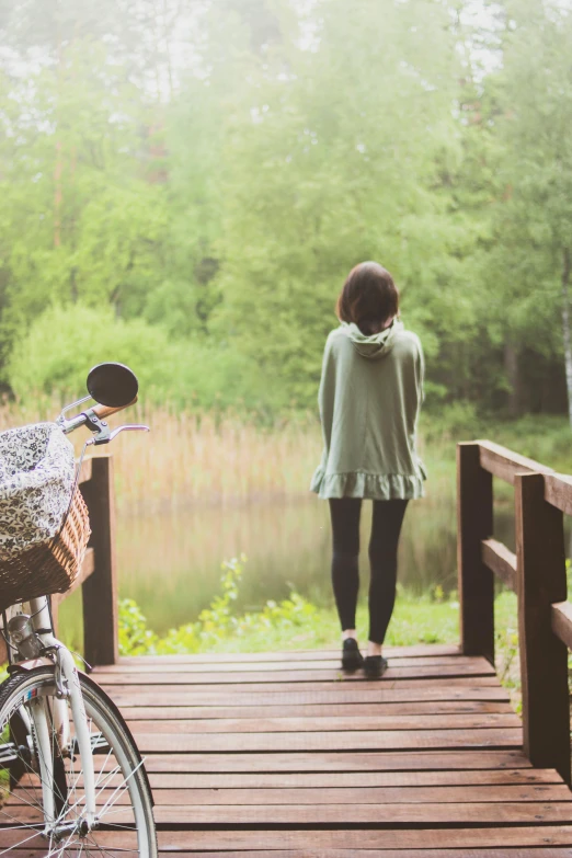 woman walking over a bridge over a river