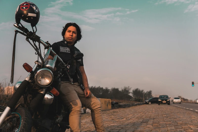 a man is sitting on top of his motorcycle