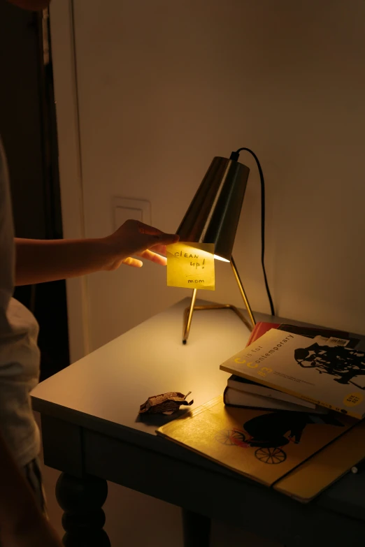 a lady is holding a lamp over a table