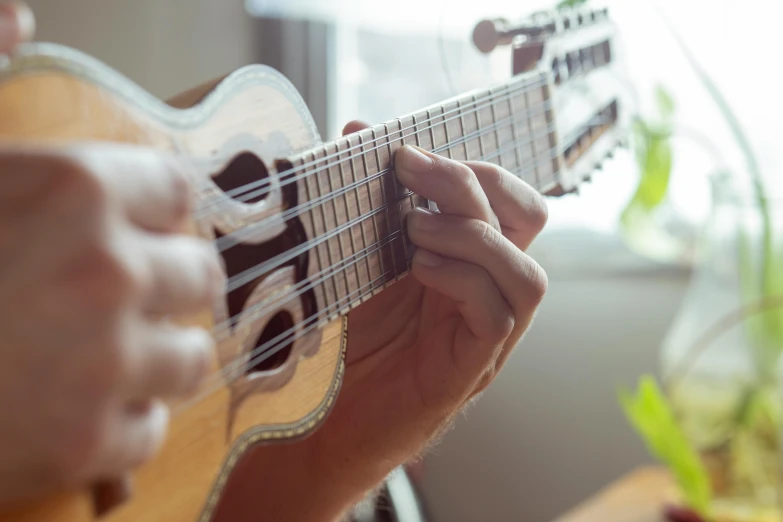 a person is playing the guitar while they hold it