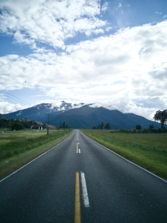 a road with some mountains in the background