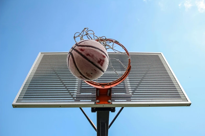 a basketball is in the middle of the hoop